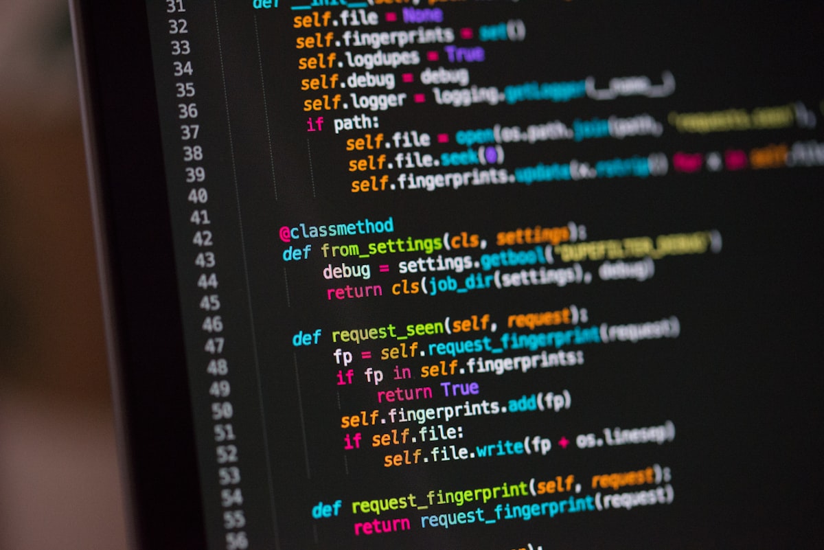 Code on dark screen with warm ambient light